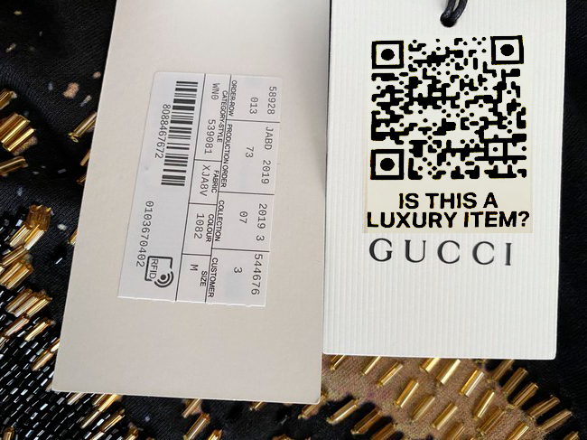 An Is This a Luxury Item QR-code sticker placed on a Gucci garment tag
