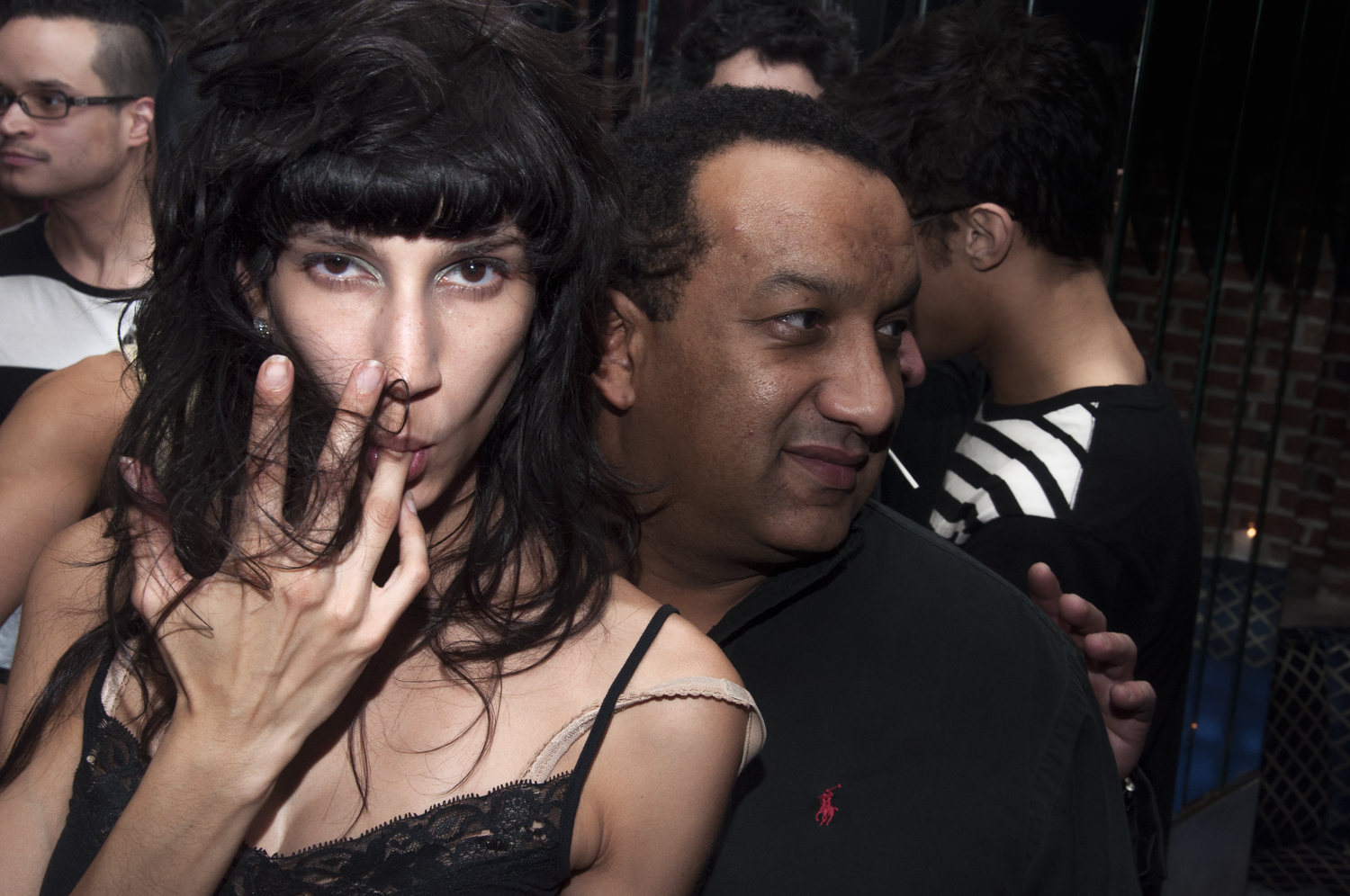 Two people pressed together in a crowded downtown club