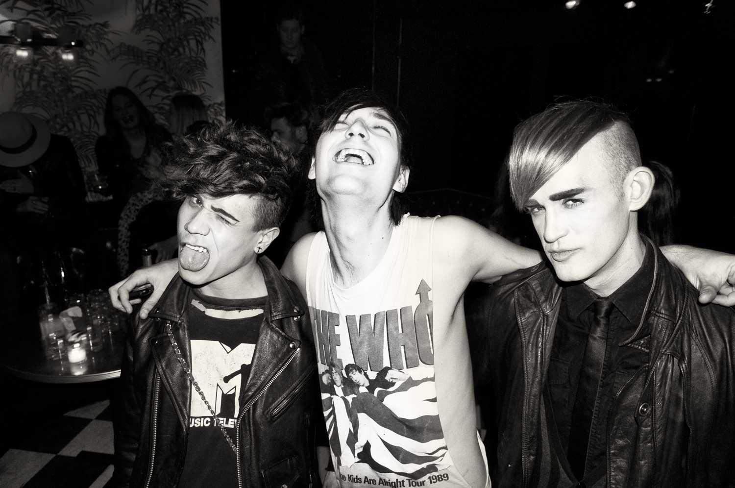 Three friends photographed in black and white at a downtown club