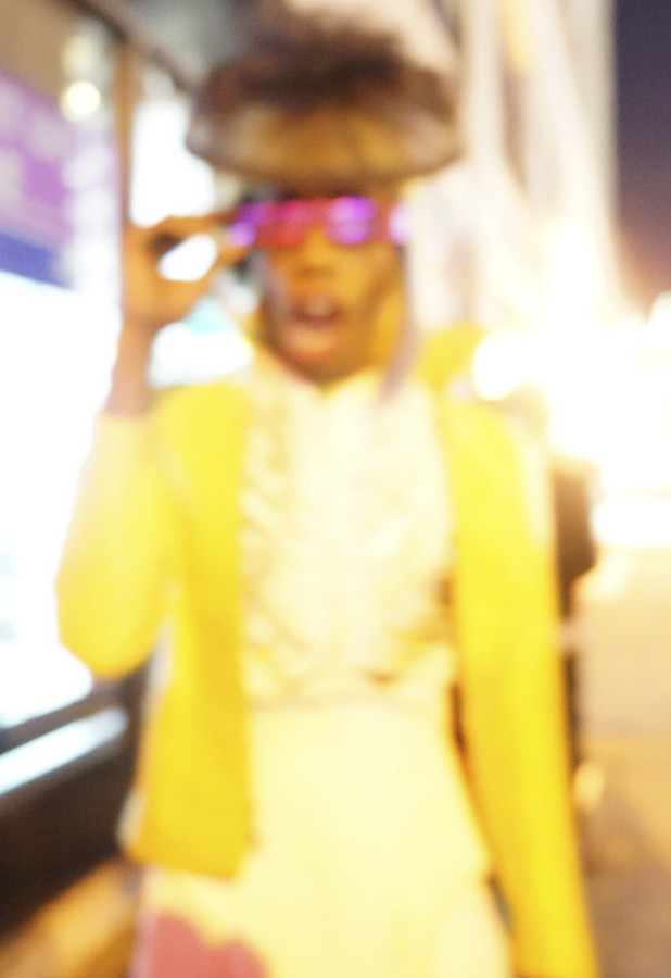 A deliberately soft-focus portrait in bright yellow and pink